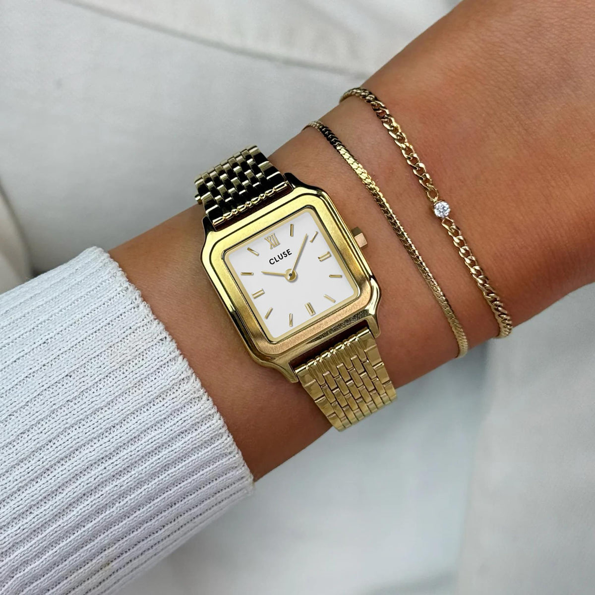 CLUSE women’s square quartz watch with white dial on gold-tone mesh bracelet