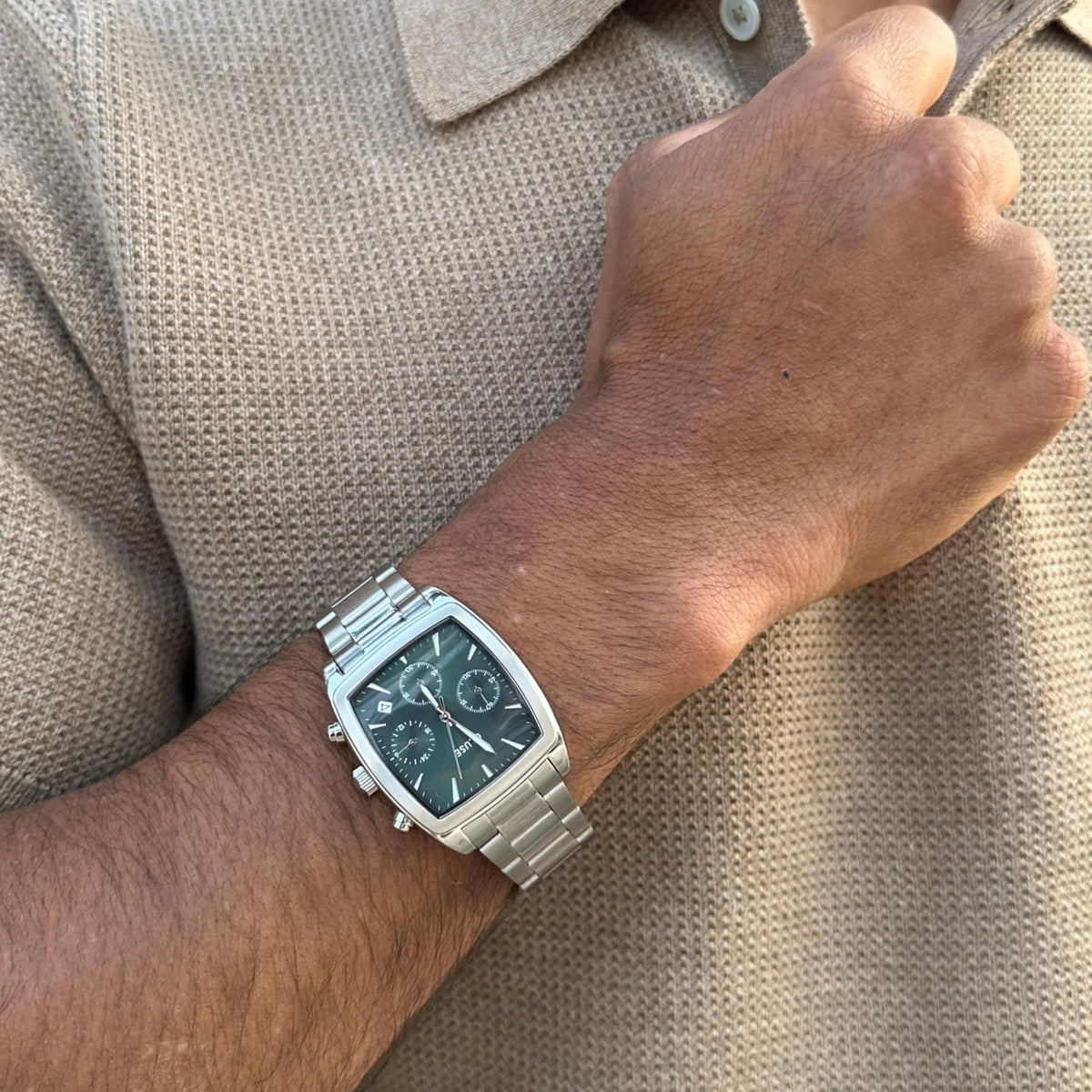 Men's steel chronograph watch with blue dial and metal bracelet on wrist