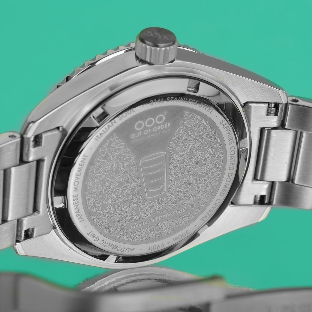 Stainless steel watch case back with engraved text and screw-down crown