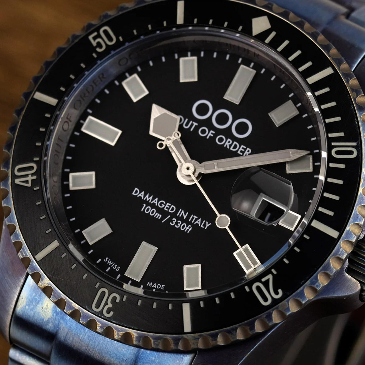 Men's distressed quartz watch close-up: black dial, silver markers, detailed hands and bezel.