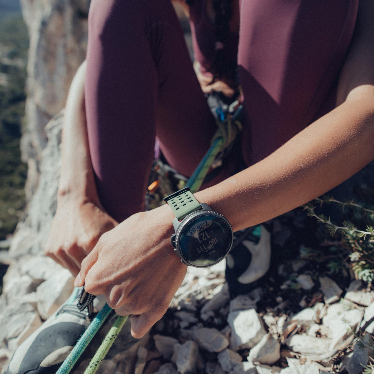Suunto Vertical Titanium Solar Forest SS050859000 lifestyle view on rock climber holding a rope