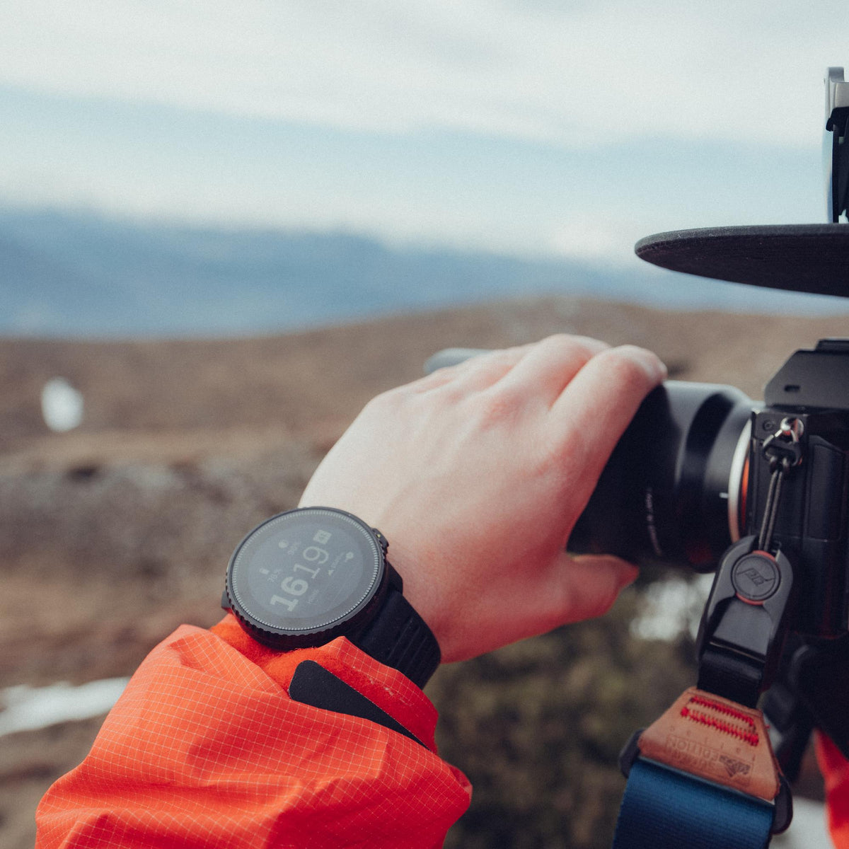 Suunto Vertical Solar All Black SS050978000 outdoor lifestyle wrist view while operating a camera
