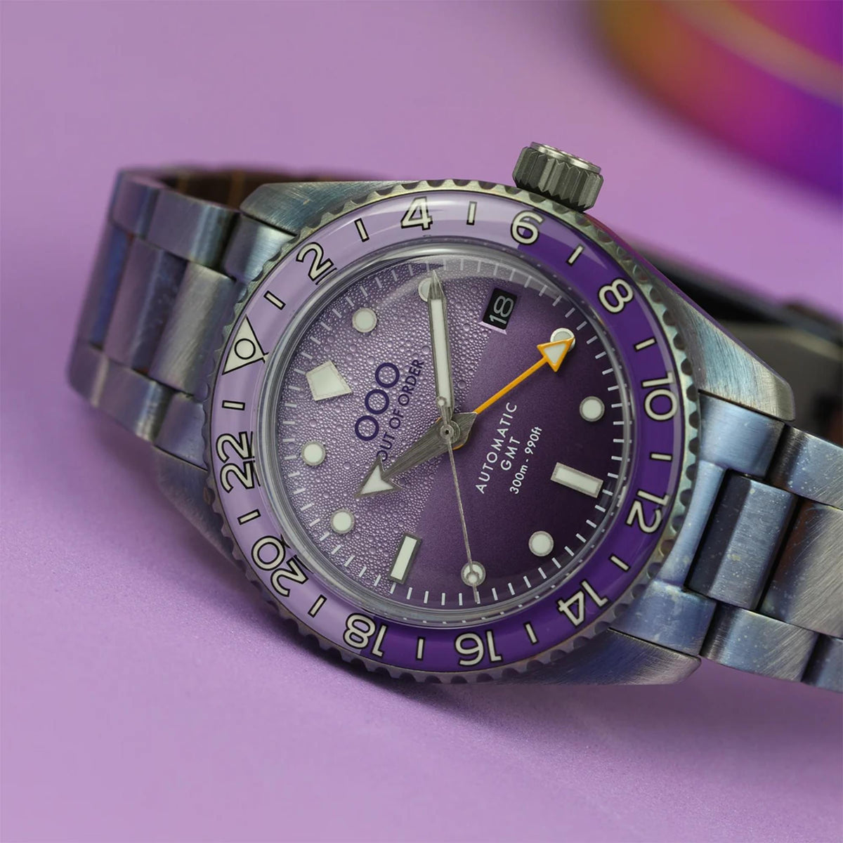 Men's automatic wristwatch with purple textured dial and dark steel link bracelet