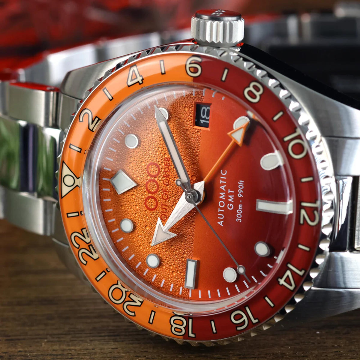 Orange dial automatic GMT watch with steel bracelet and rotating bezel