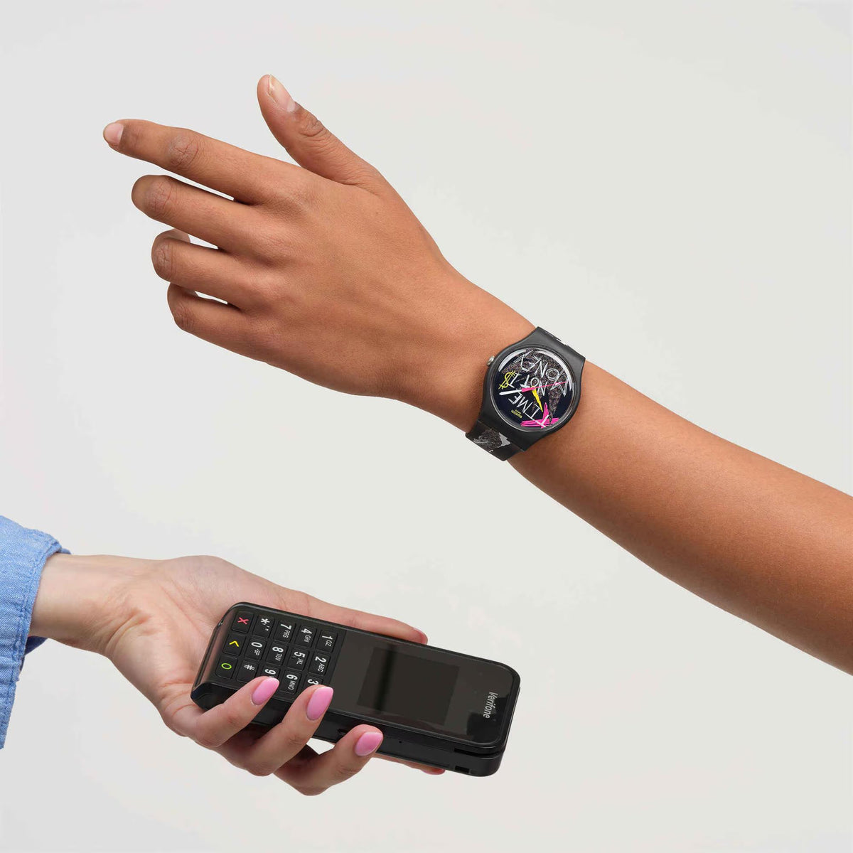 Black silicone wristwatch on wrist with abstract colorful analog dial