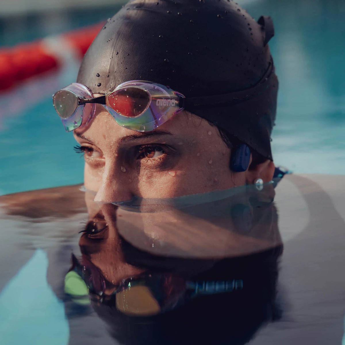 Suunto Aqua SS051124000 light tidal black sports open-ear wireless headphones close-up of swimmer wearing open-ear audio gear in pool