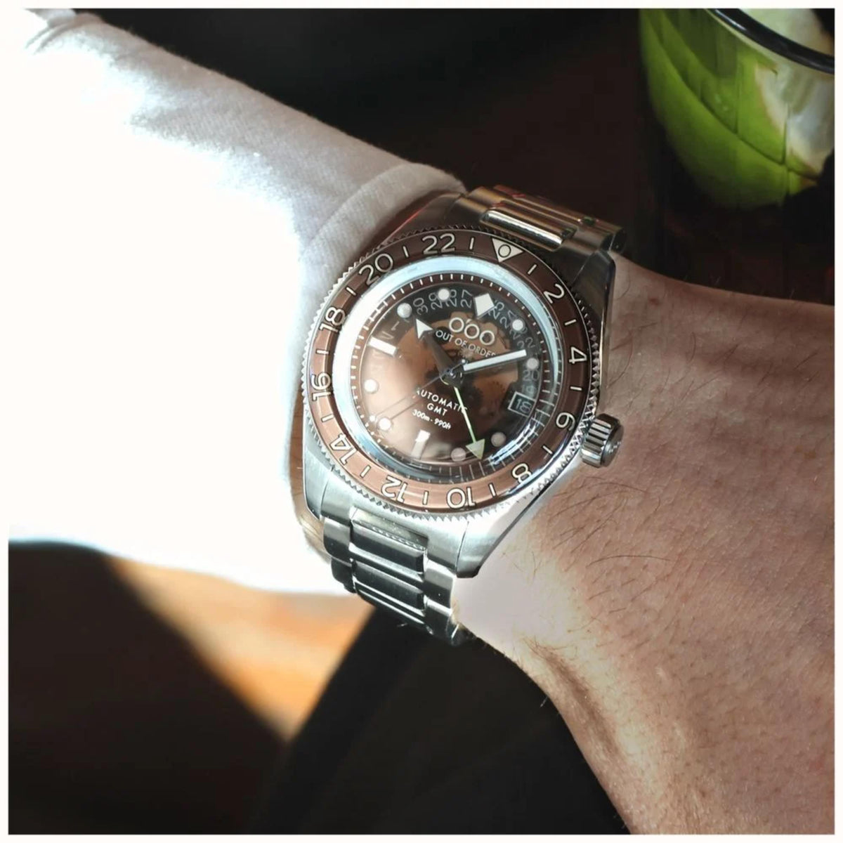 Men's automatic steel watch on wrist, dark dial with bezel markers and date window
