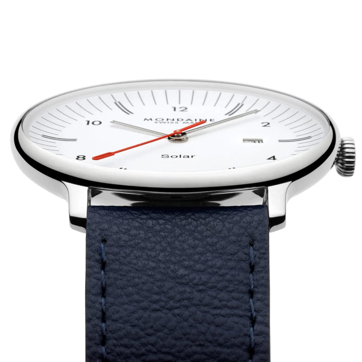 A close-up shot of Mondaine Doppio watch highlighting the sapphire crystal, silver bezel, textured crown, and the textured leather of the blue strap where it meets the lugs