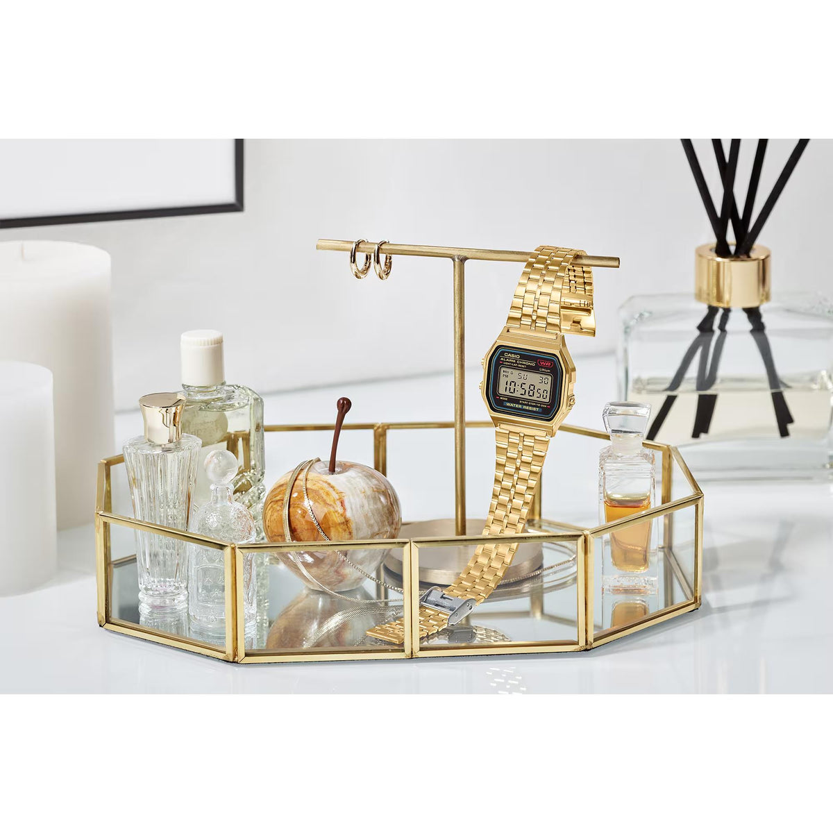 Casio digital steel quartz watch with gold-tone metal bracelet on display stand