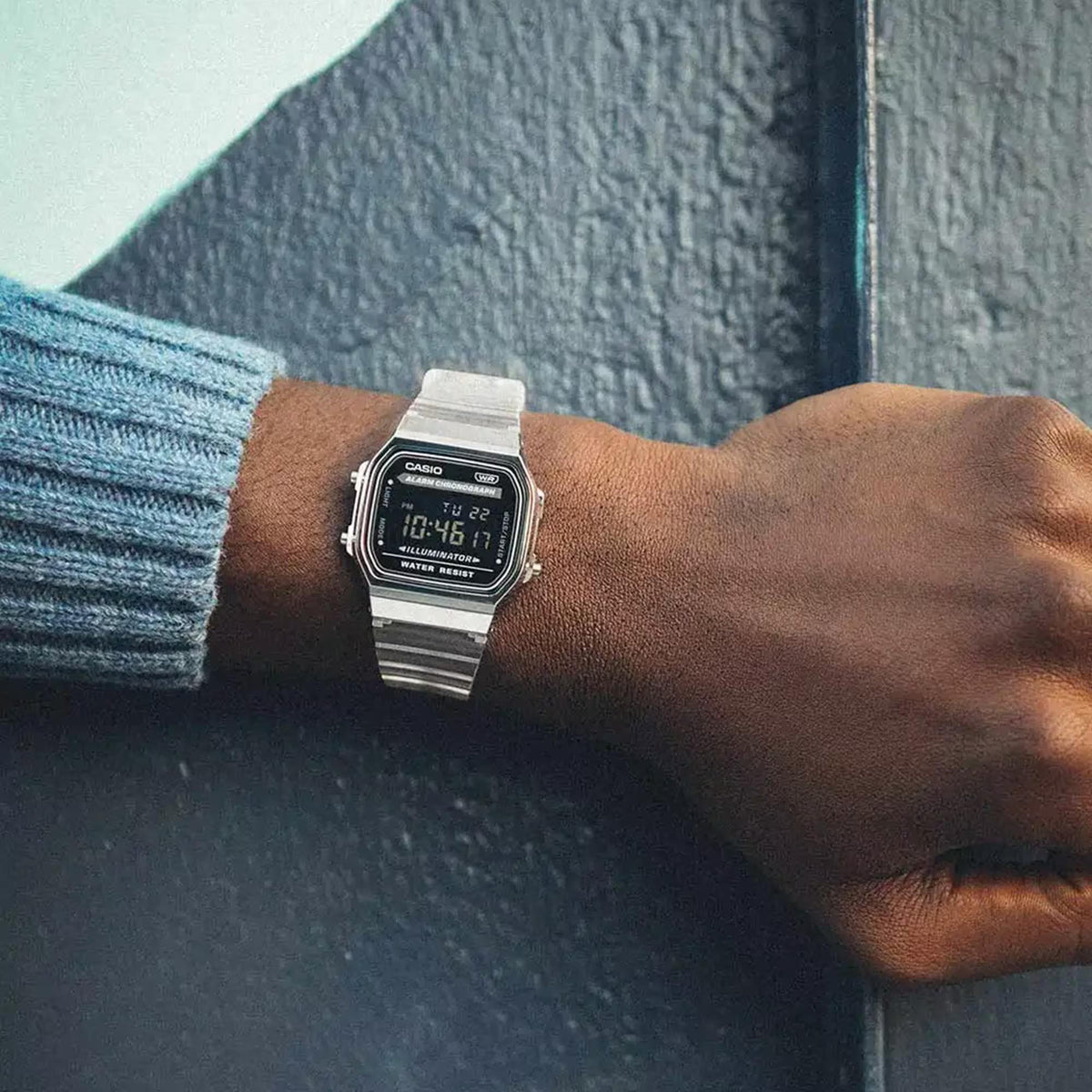 Wrist shot of the Casio Vintage Quartz Digital Resin Strap Watch A168XES-1BEF worn over a blue sweater sleeve