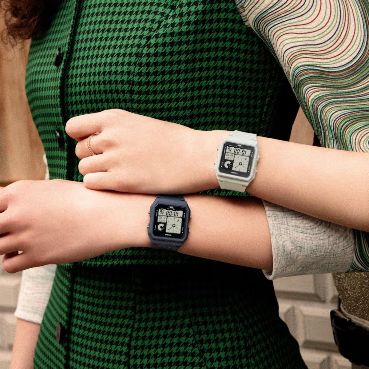 Resin strap digital watch with LCD display on wrist, black case and band