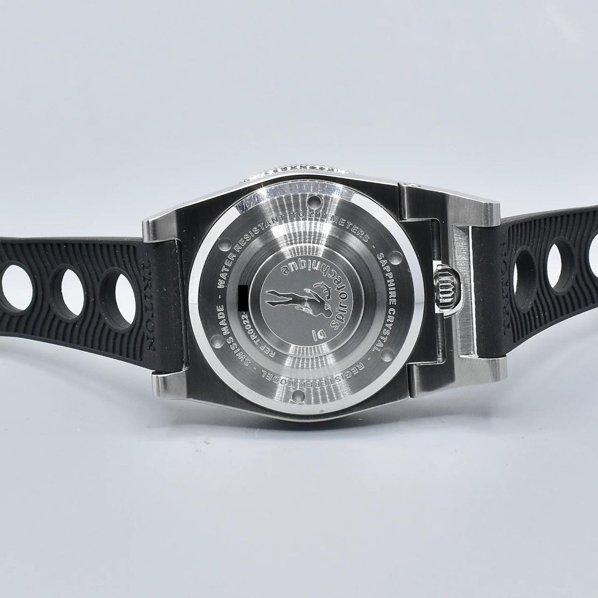 Men's steel dive watch with engraved caseback and black perforated rubber strap
