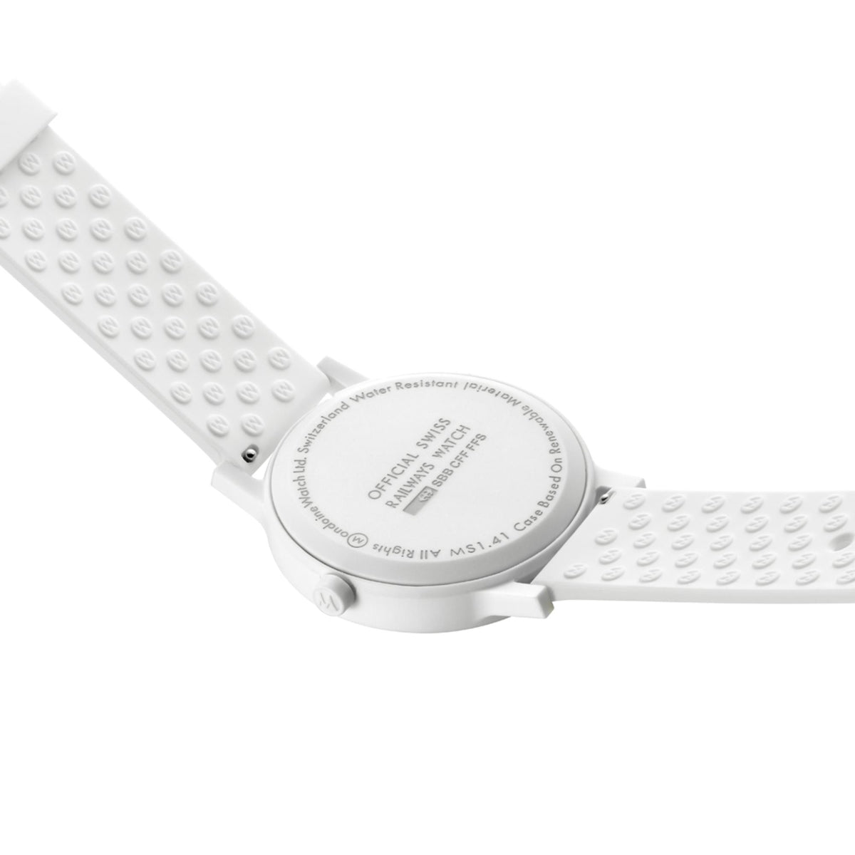 Mondaine Essence watch caseback on white silicone strap, embossed markings on the back