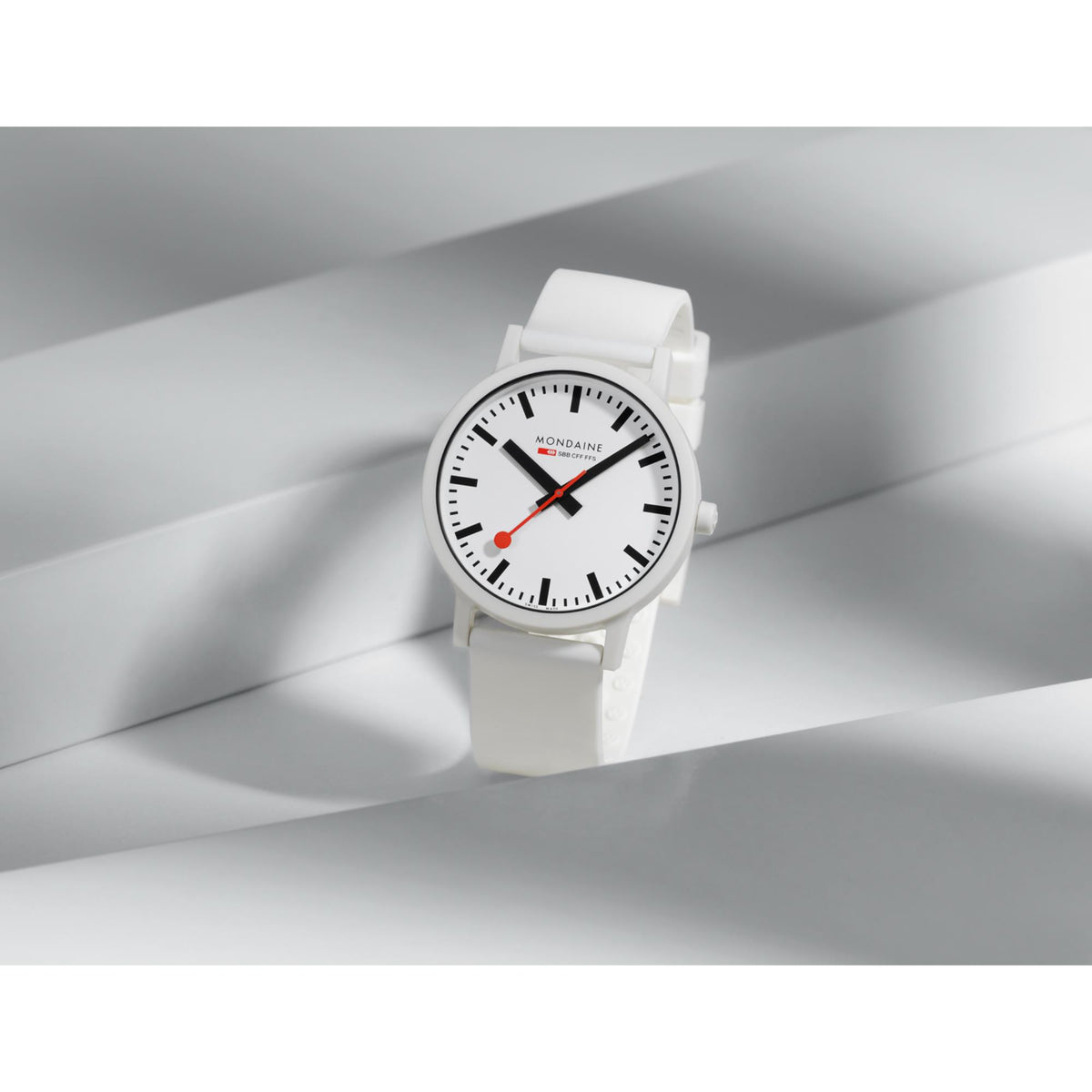 Mondaine Essence wristwatch with white dial and white silicone strap, angled front view