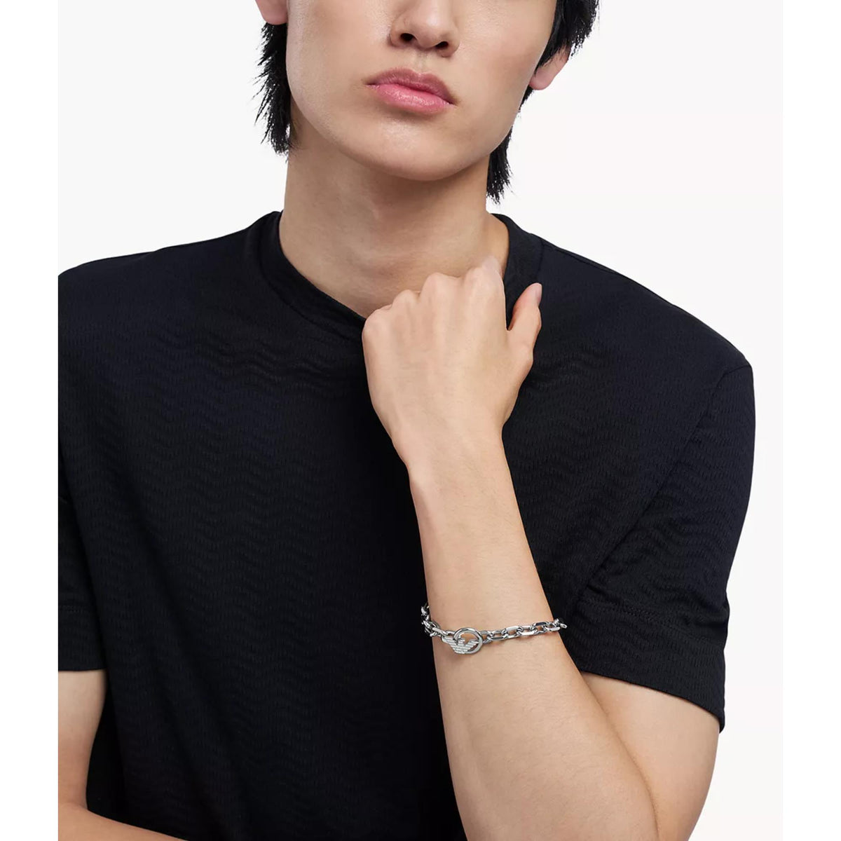 Model wearing Emporio Armani mens silver tone stainless steel chain ID bracelet EGS3236040 on wrist