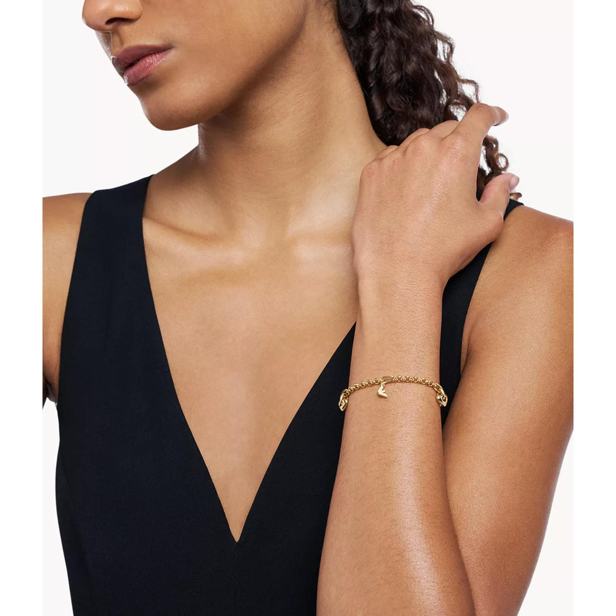 Model wearing Emporio Armani womens gold tone link charm bracelet EGS3268710 on wrist