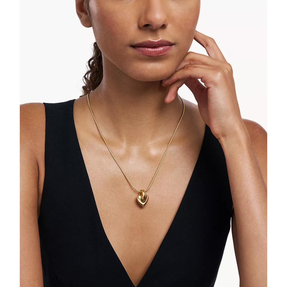 Model wearing Emporio Armani womens gold tone heart pendant necklace EGS3265710