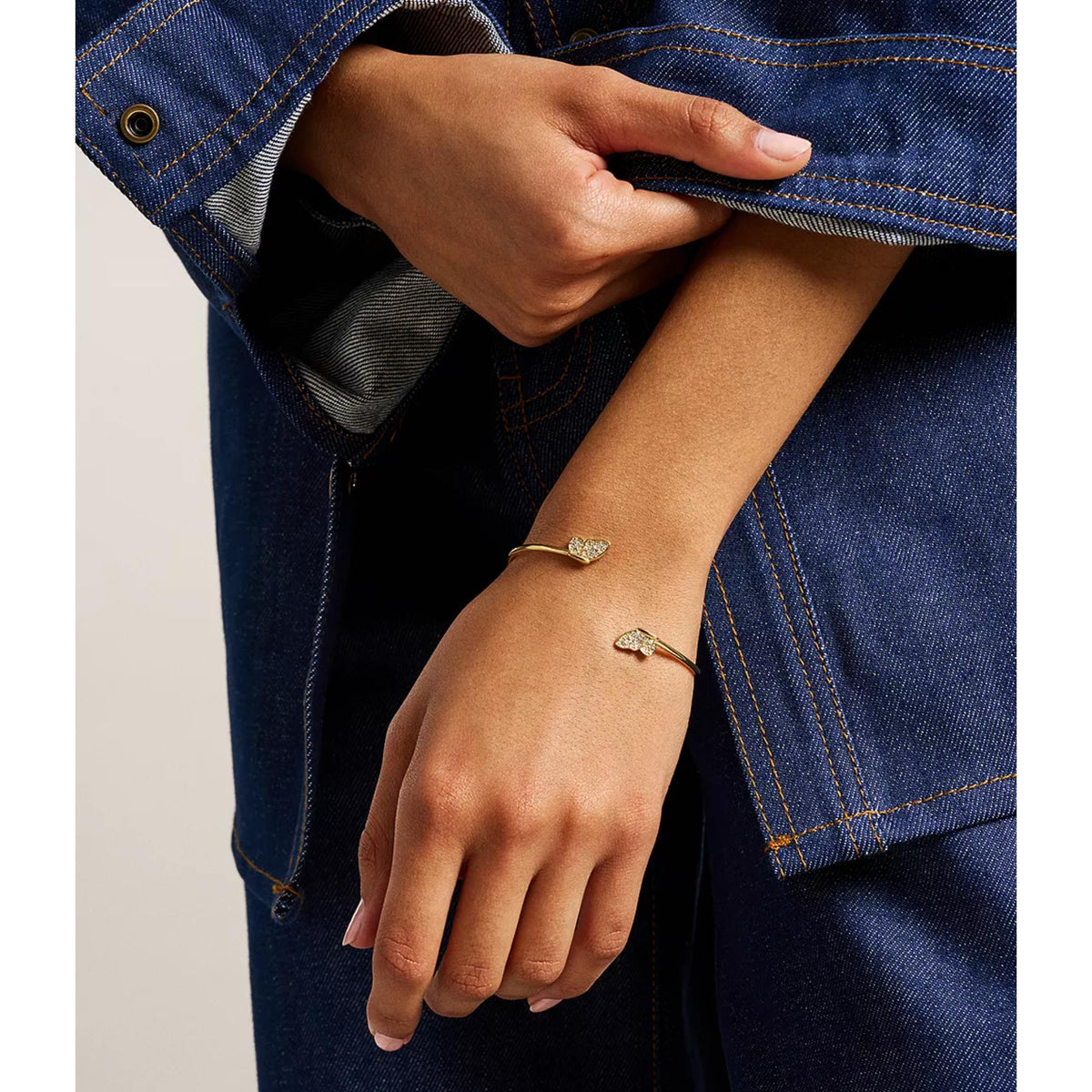 Fossil gold-tone pavé butterfly cuff bracelet on wrist