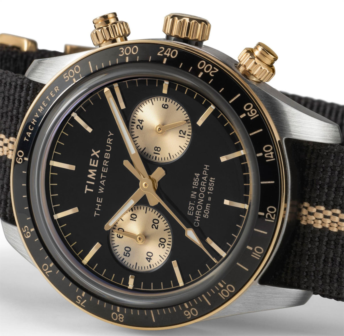 Timex Waterbury chronograph watch with black dial, gold bezel, and black fabric strap