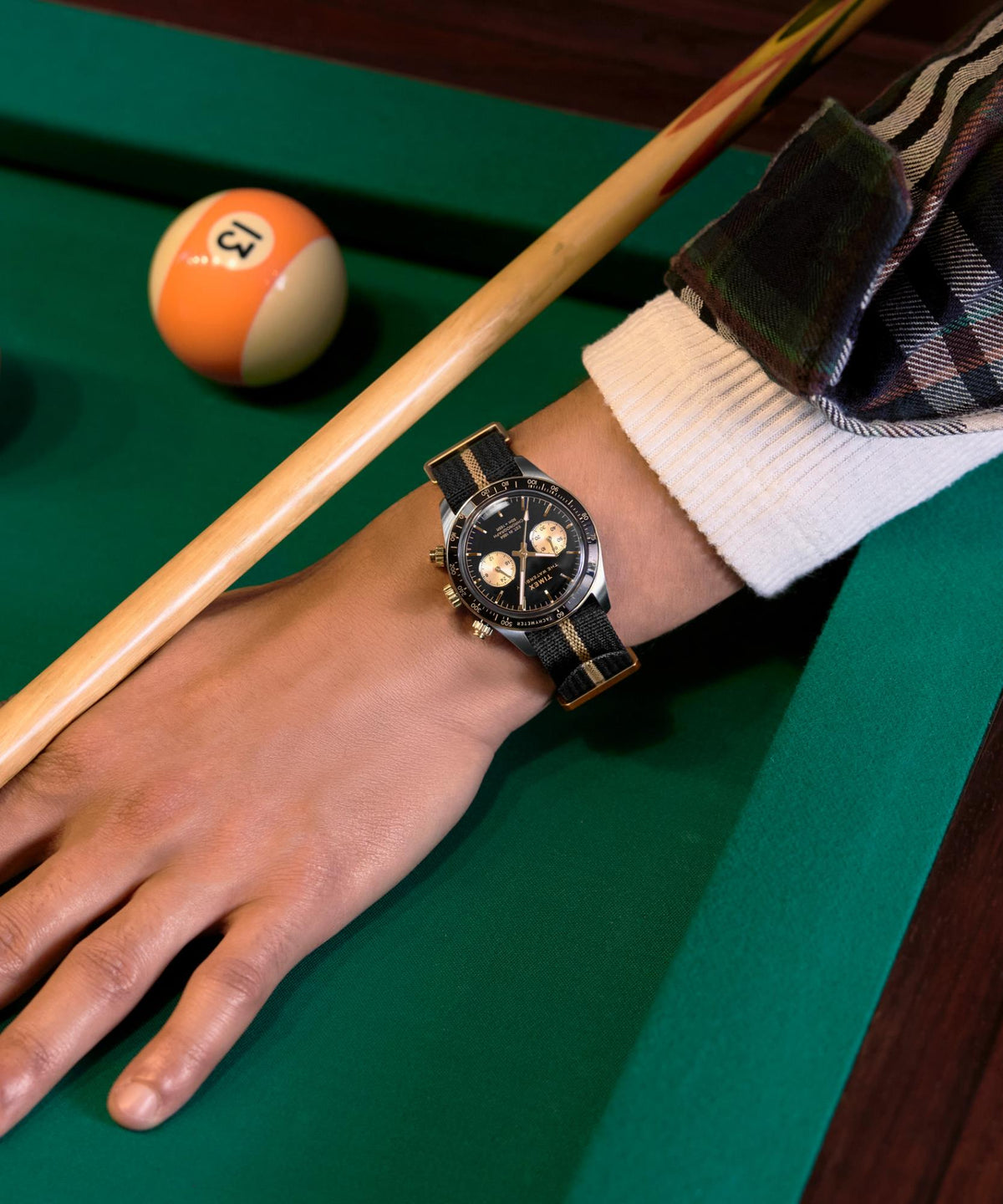 Men's Timex Waterbury chronograph on wrist with black dial and black fabric strap