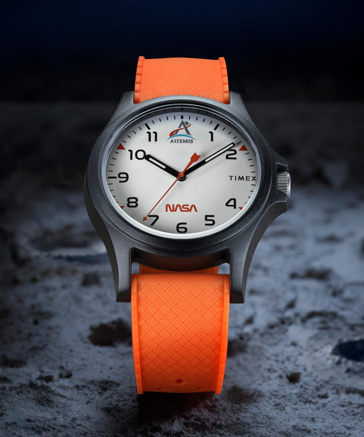 Quartz wristwatch on dark background: white dial, black case, orange silicone strap