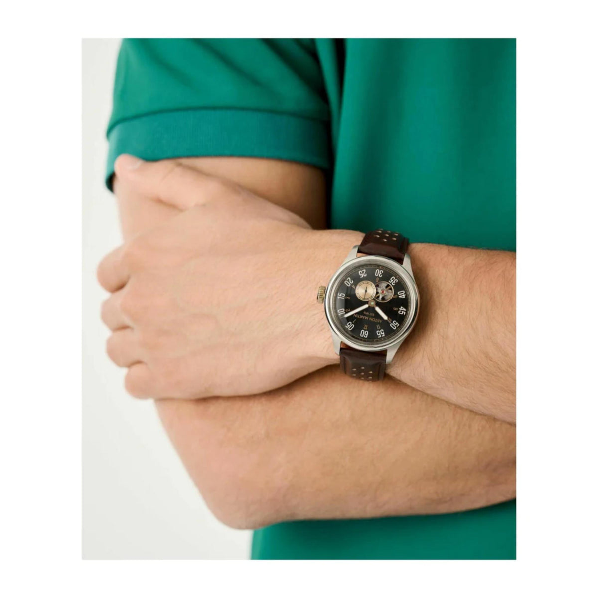 Men's automatic watch with black dial and brown leather strap on wrist