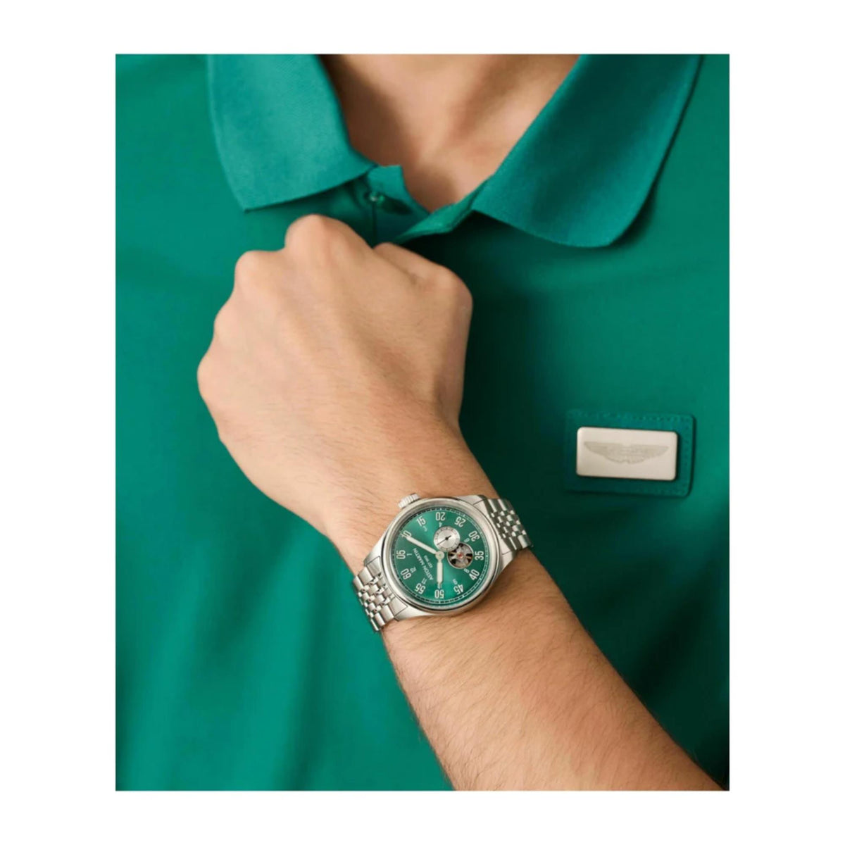 Aston Martin MTTS1F504 on-wrist view with green polo shirt lifestyle shot