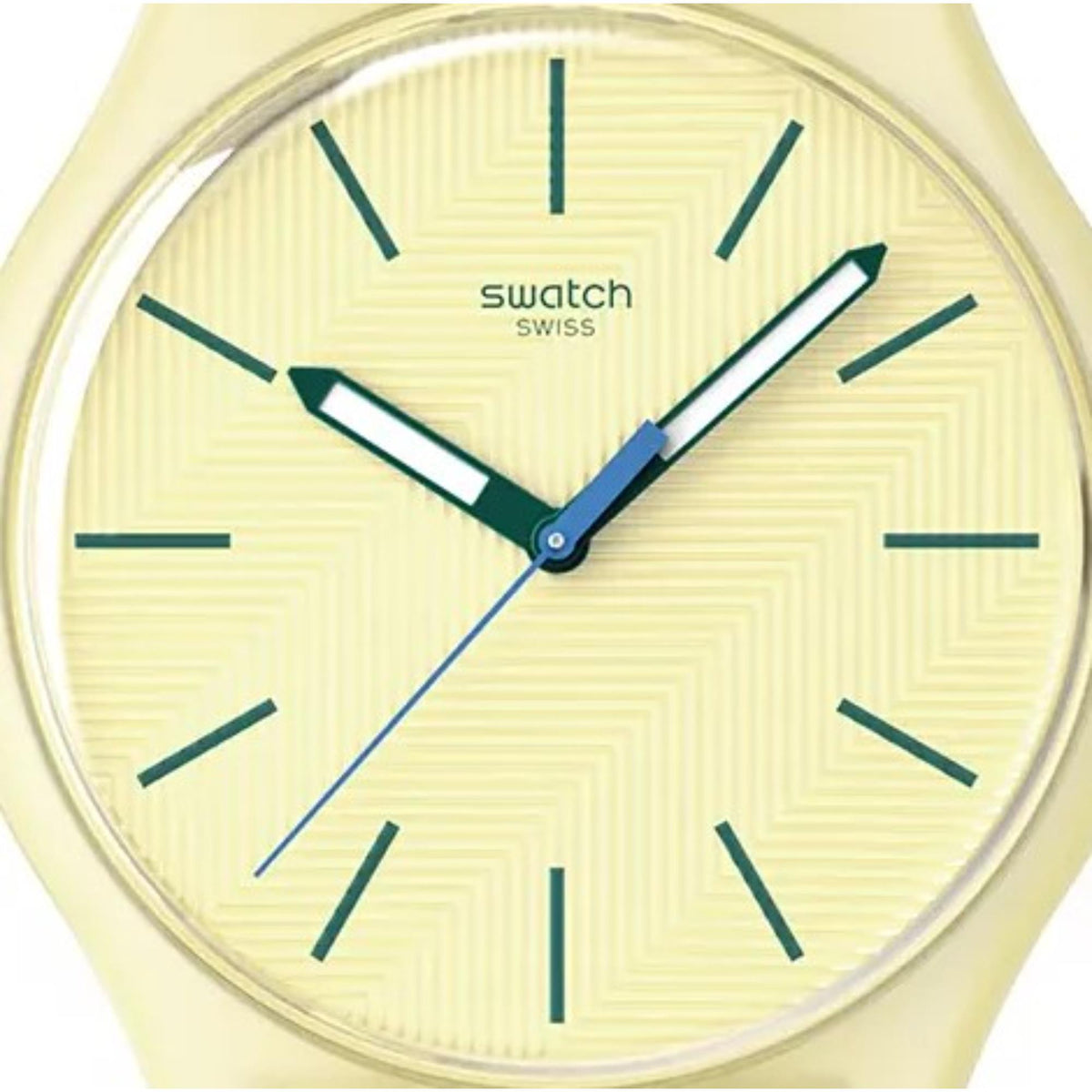 Round light yellow dial quartz watch with teal hour markers and blue hands