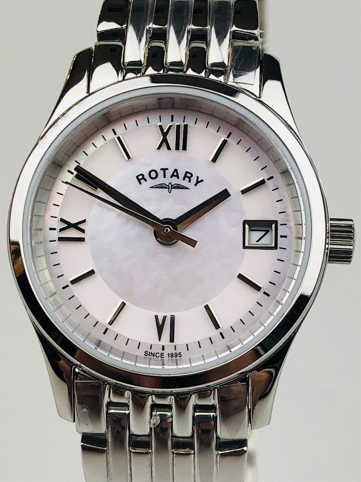 Front view stainless steel watch with mother-of-pearl dial, Roman numerals, and date window