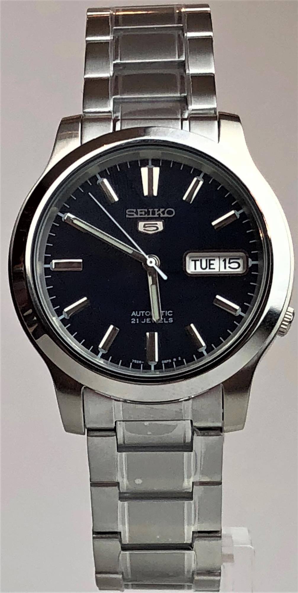 Men's stainless steel automatic watch with dark blue dial, baton hour markers, and day-date window