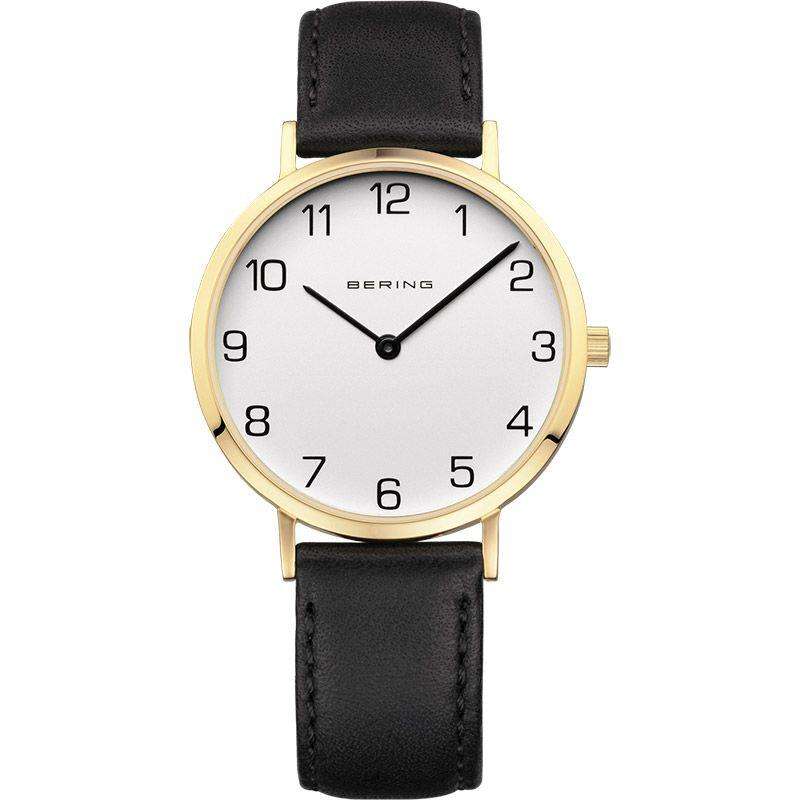 Gold-tone round ladies watch on black leather strap, white dial with Arabic numerals.