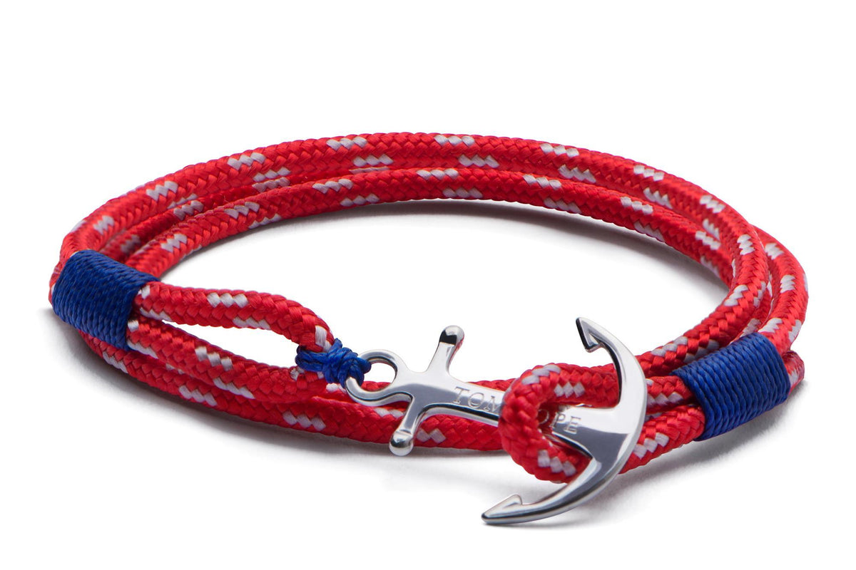 Red braided bracelet with blue end details and sterling silver anchor pendant