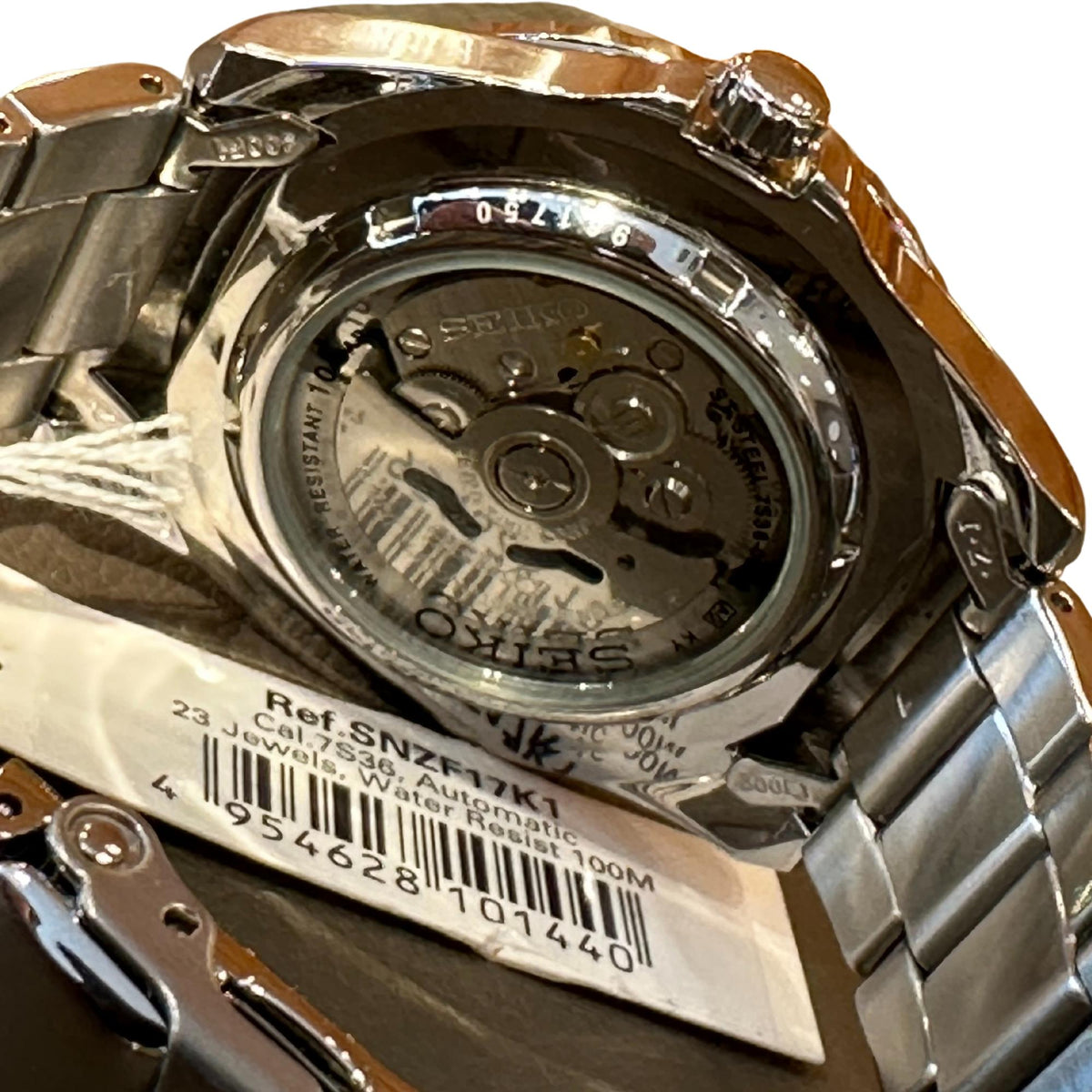 Stainless steel Seiko automatic watch caseback with visible movement and engraved ring