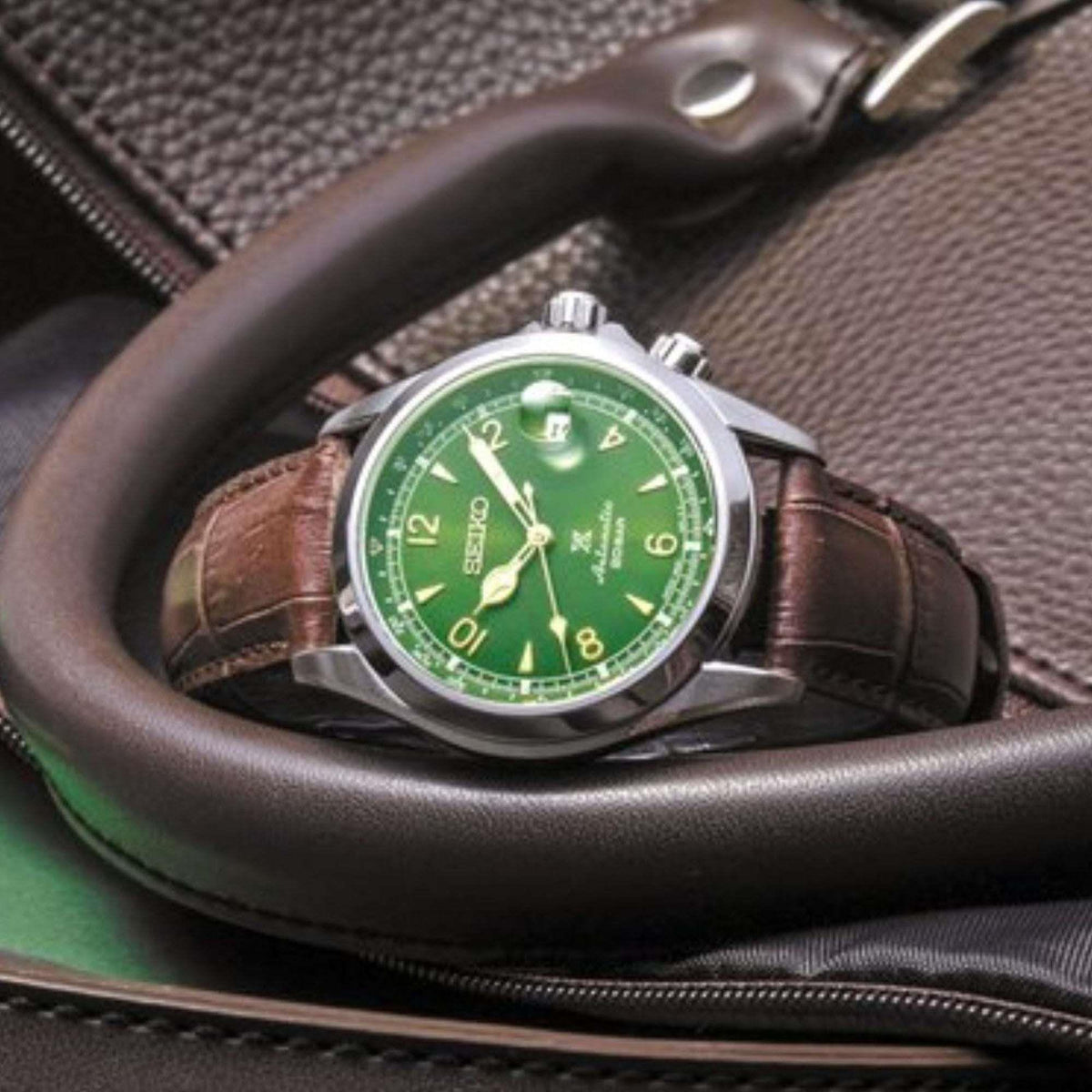 Seiko Prospex Alpinist watch with bright green dial, brown leather strap, and crown