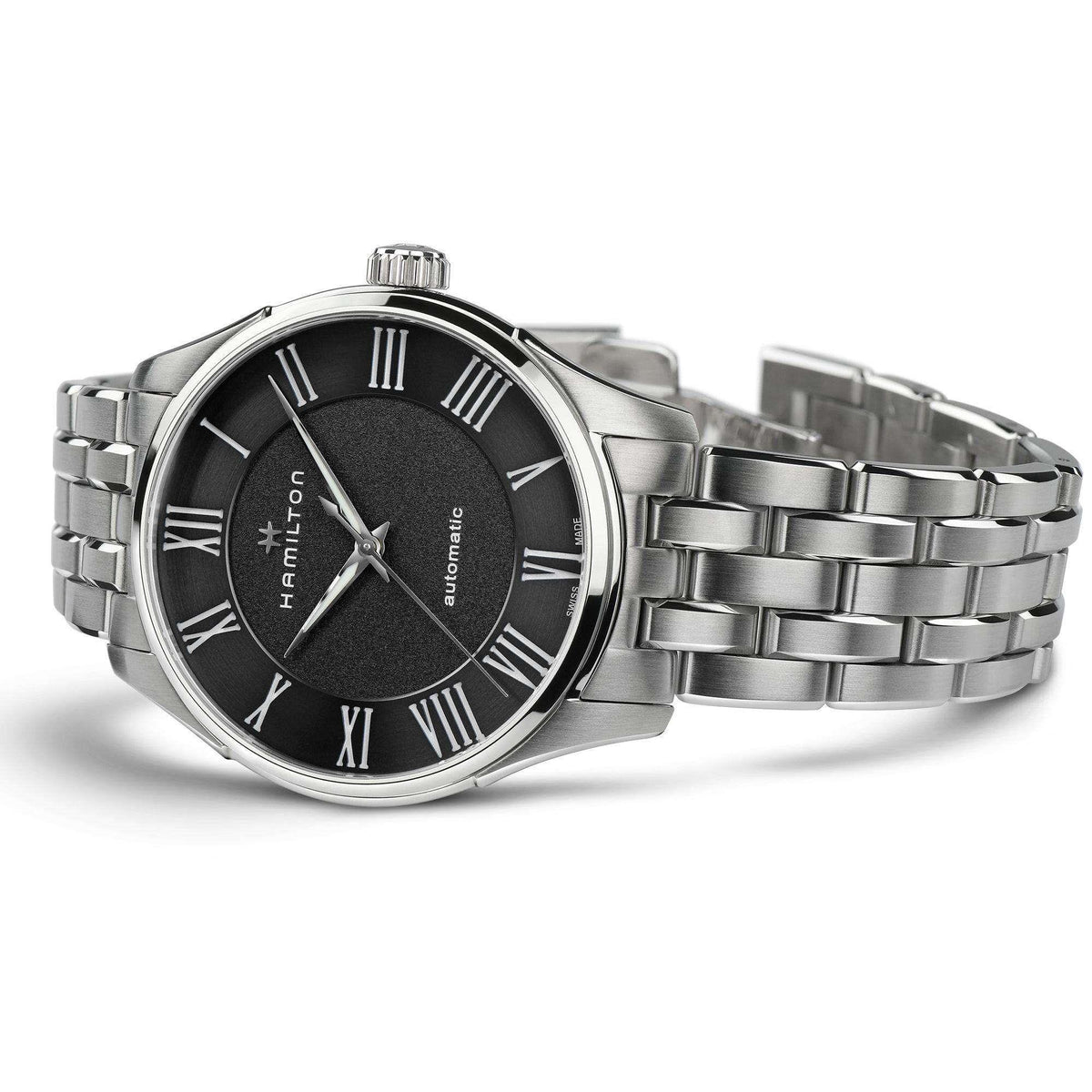 Steel automatic wristwatch with black dial, Roman numeral markers, and linked metal bracelet