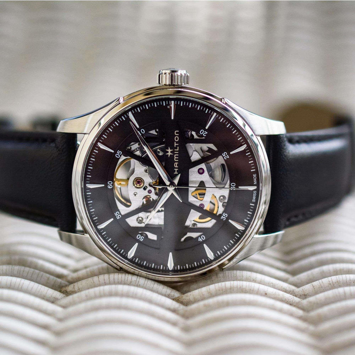 Automatic skeleton dial wristwatch with silver-tone case and black leather strap