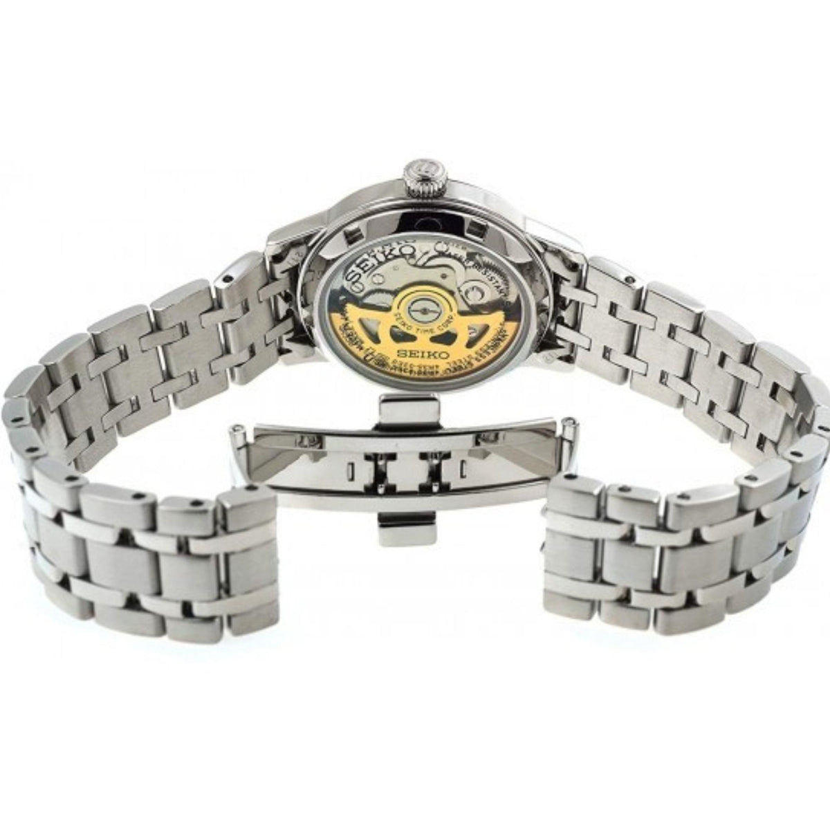 Stainless ladies watch caseback showing mechanical movement, linked silver bracelet.