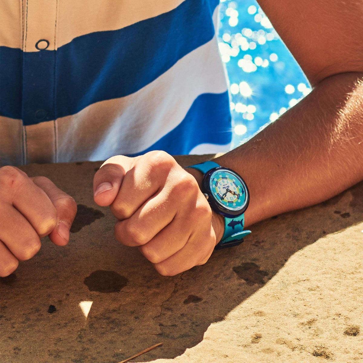 Kids Flik Flak quartz watch on wrist with blue shark print strap and round dial