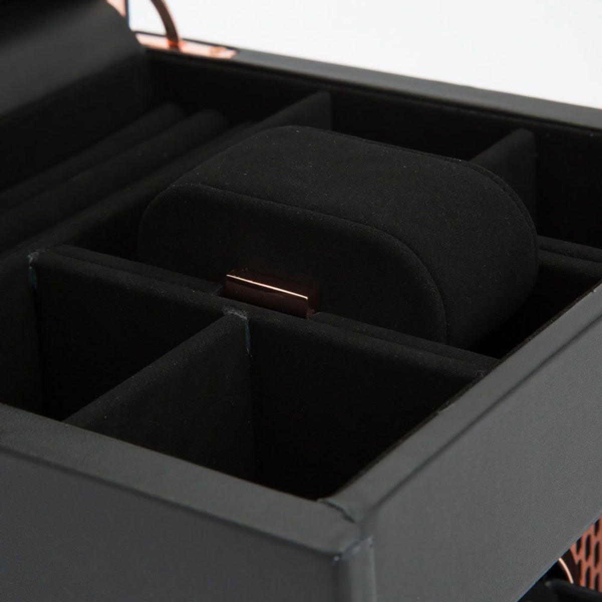 Single watch winder interior with black watch cushion and copper support rod