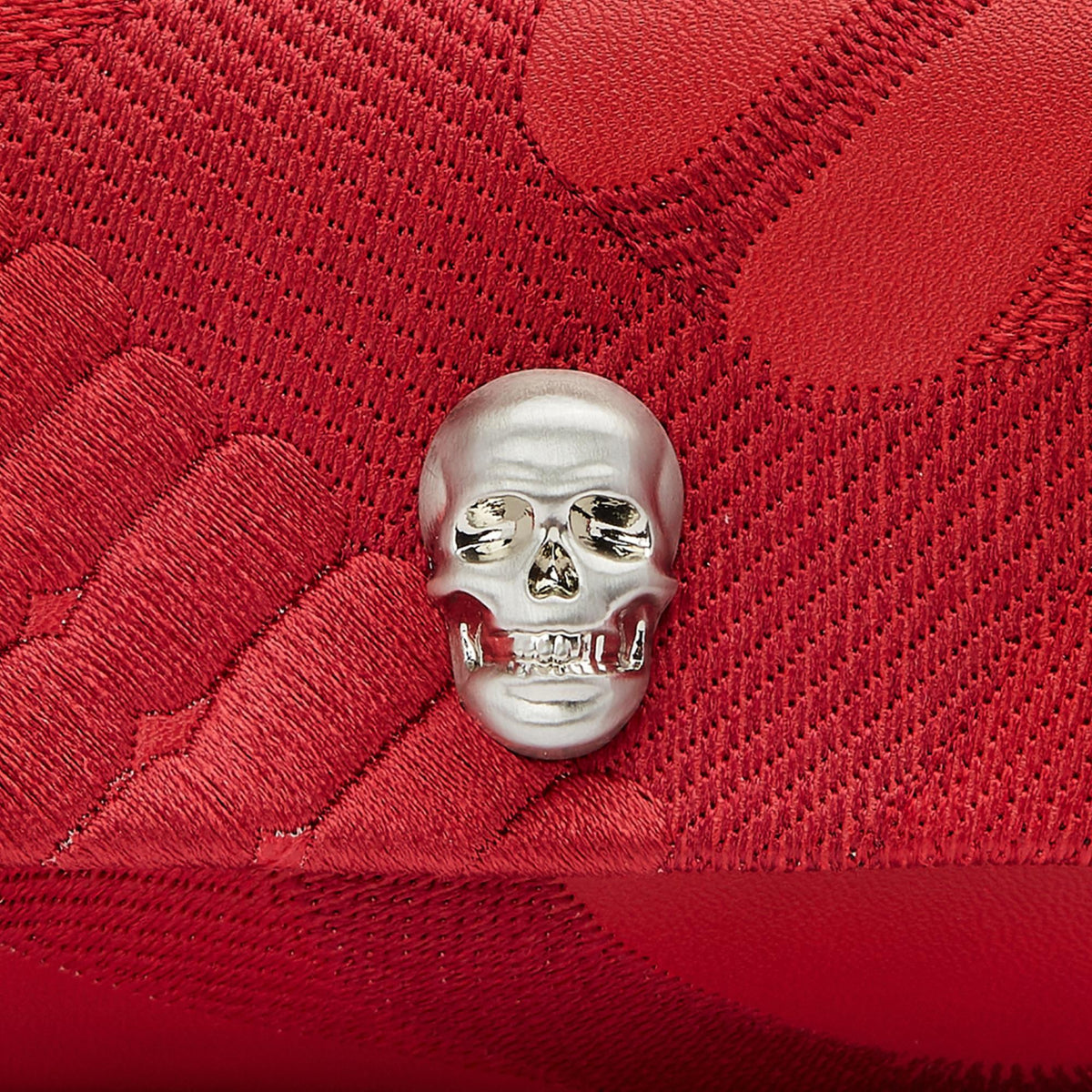 Red watch roll panel with skull metal emblem and textured fabric