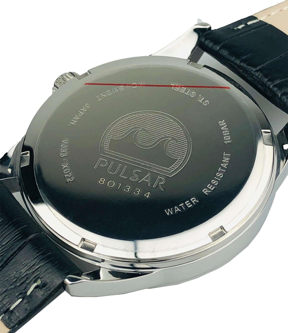 Stainless steel watch case back with engraved details, black leather strap