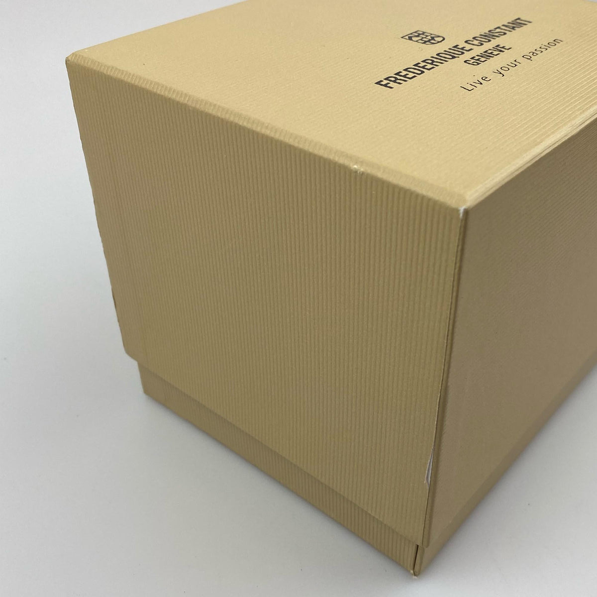 Damaged cardboard watch box with scuffed corner and printed text on lid