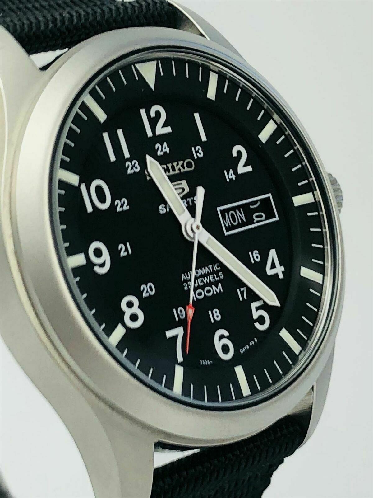 Seiko 5 Sports men's watch close-up: black dial, baton markers, black NATO strap