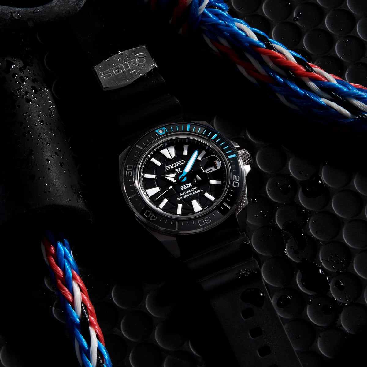 Seiko automatic diver watch with black dial and blue accents on black silicone strap