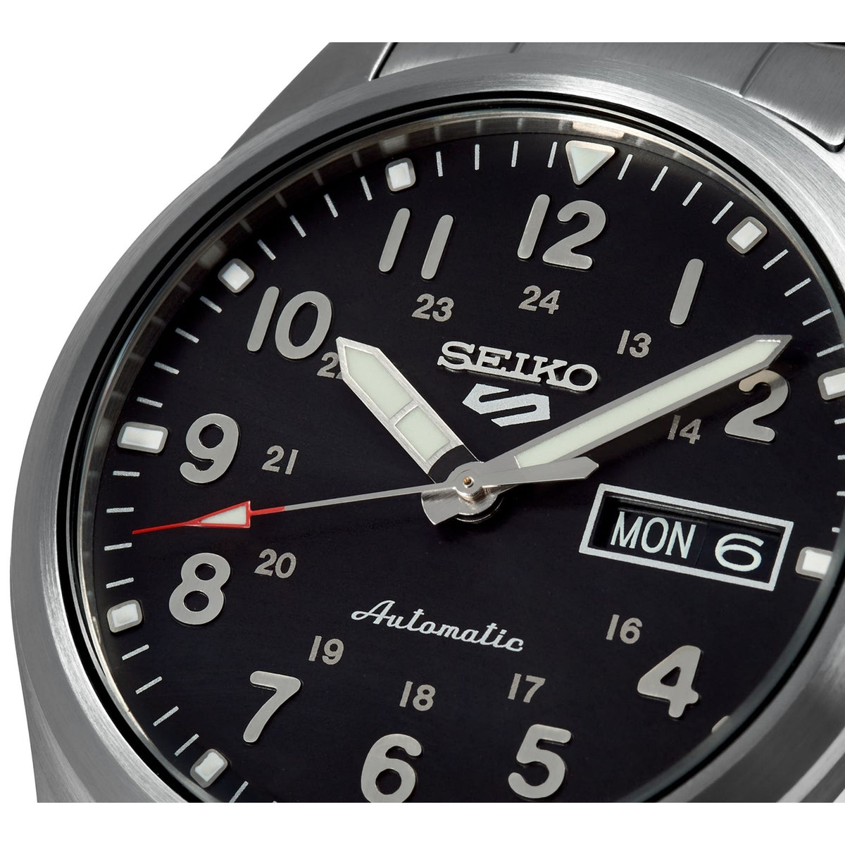 Seiko 5 Sports black dial close-up with SEIKO lettering and MON date window