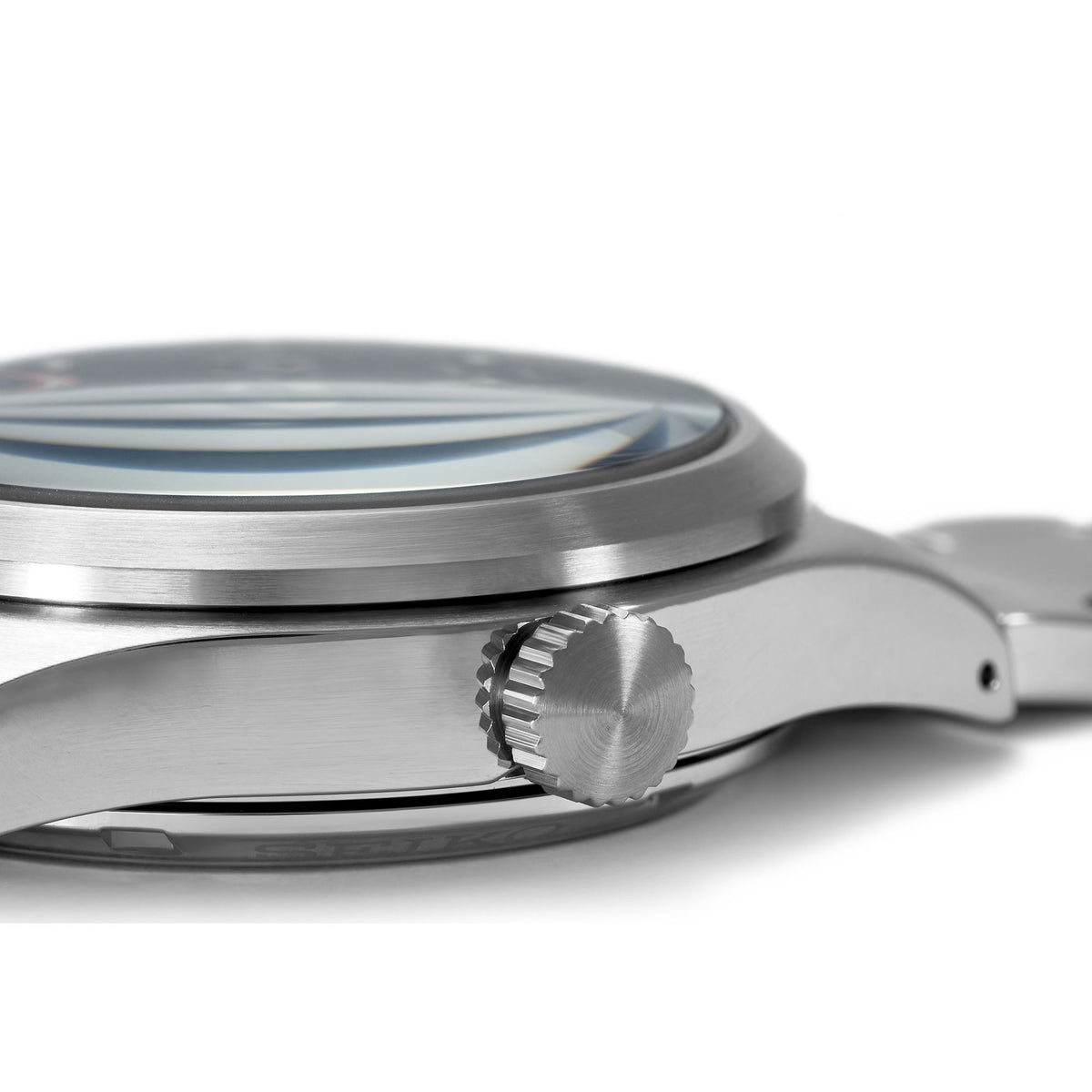 Stainless watch profile with textured crown and smooth brushed case edge