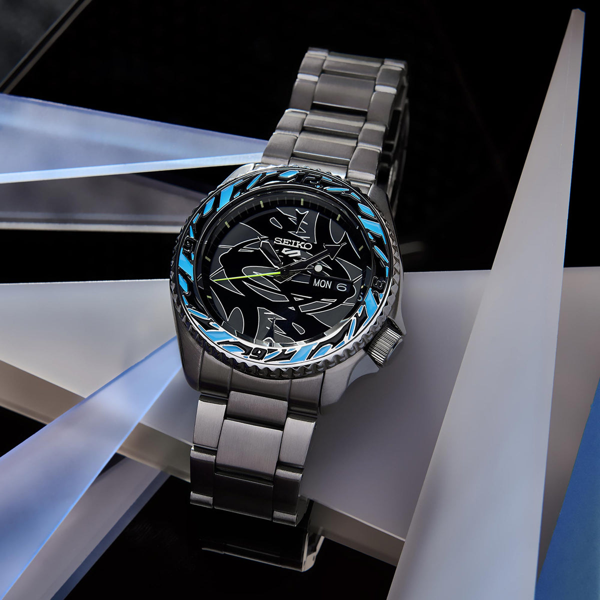 Seiko men's automatic watch with black dial and blue bezel ring, steel link bracelet