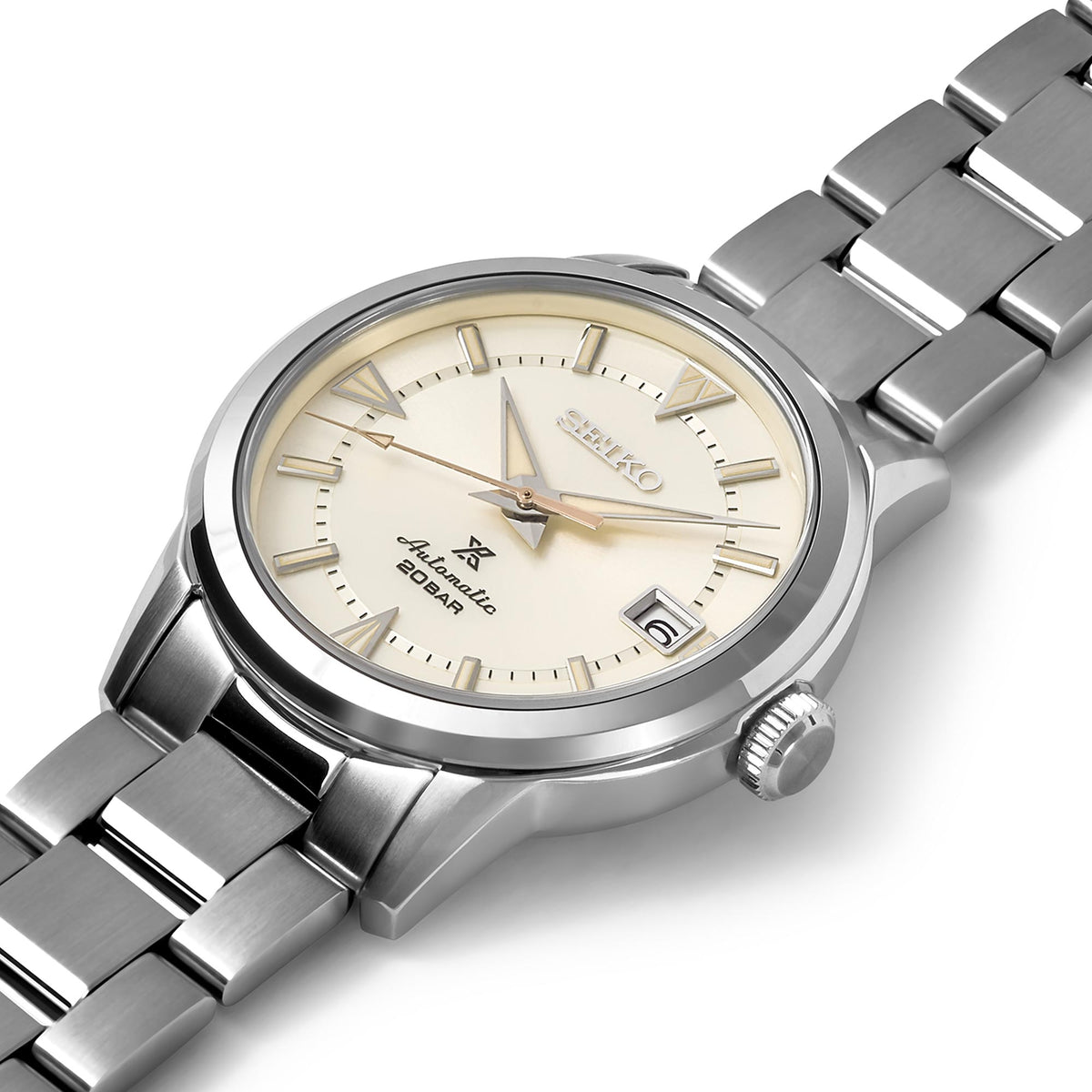Seiko Prospex stainless steel watch with cream dial, baton markers, and day-date window