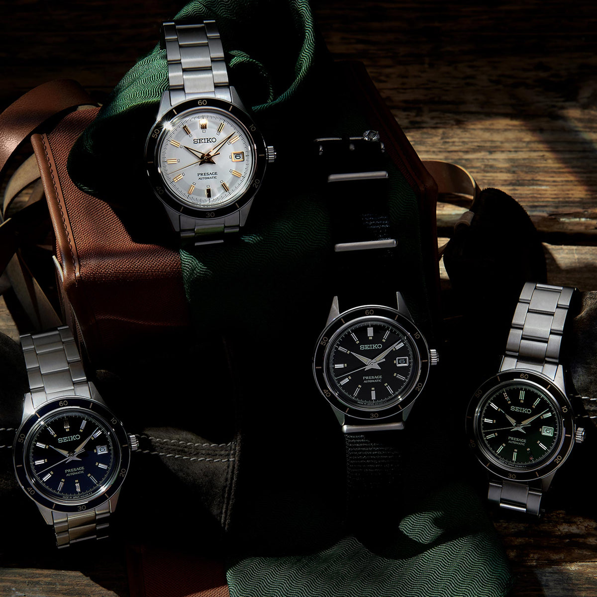 Stainless steel automatic wrist watches on fabric, several watches shown