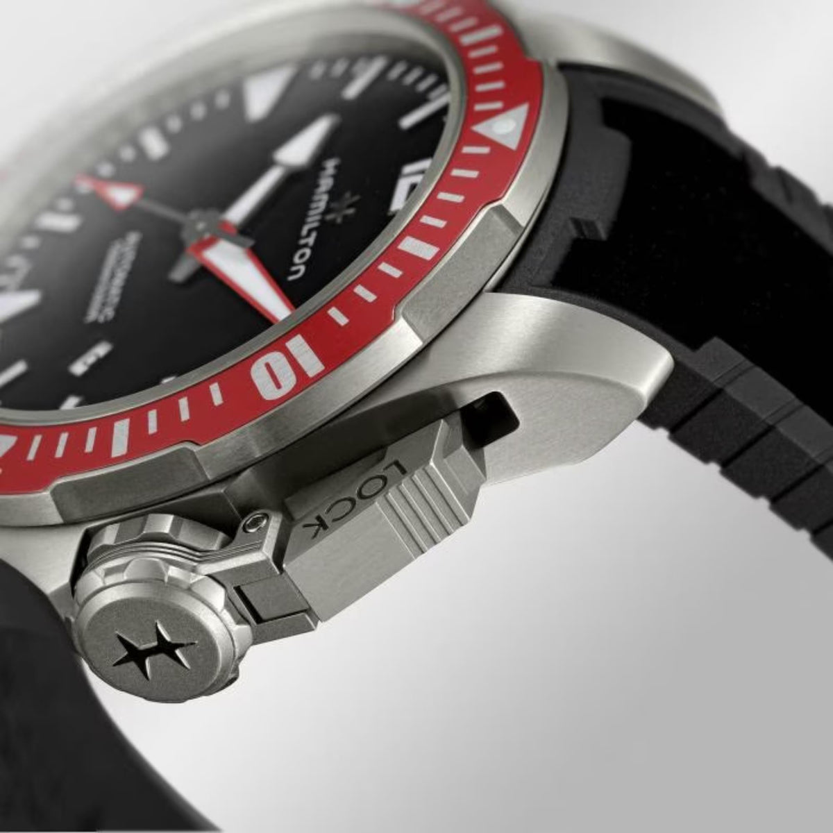 Detail side shot of automatic diver watch with black rubber strap and crown
